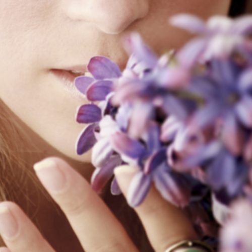 Girl smelling fresh flowers. Odour control