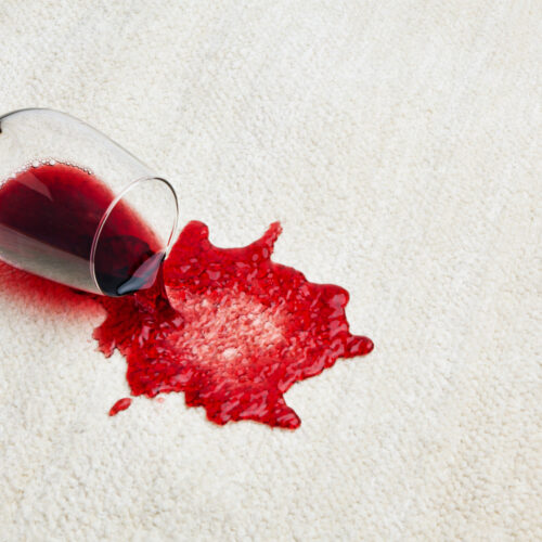 Red wine spill on white carpet