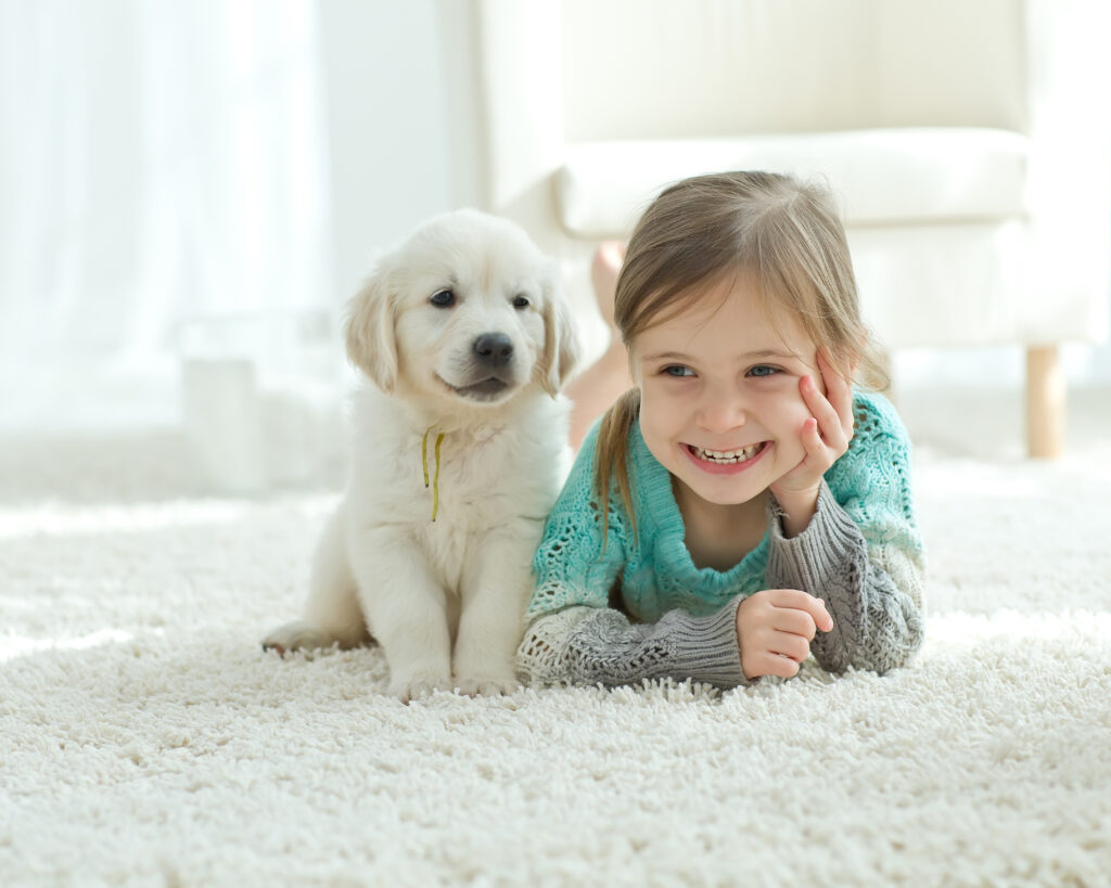 Child and dog on rug