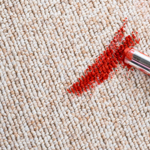 Dirty stain of lipstick on the carpet or sofa. daily life stain concept. top view