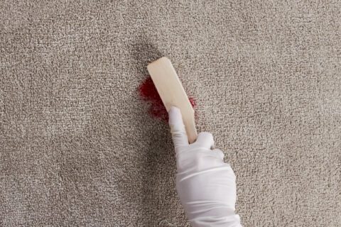 Agitate the lipstick stain with a spotting brush